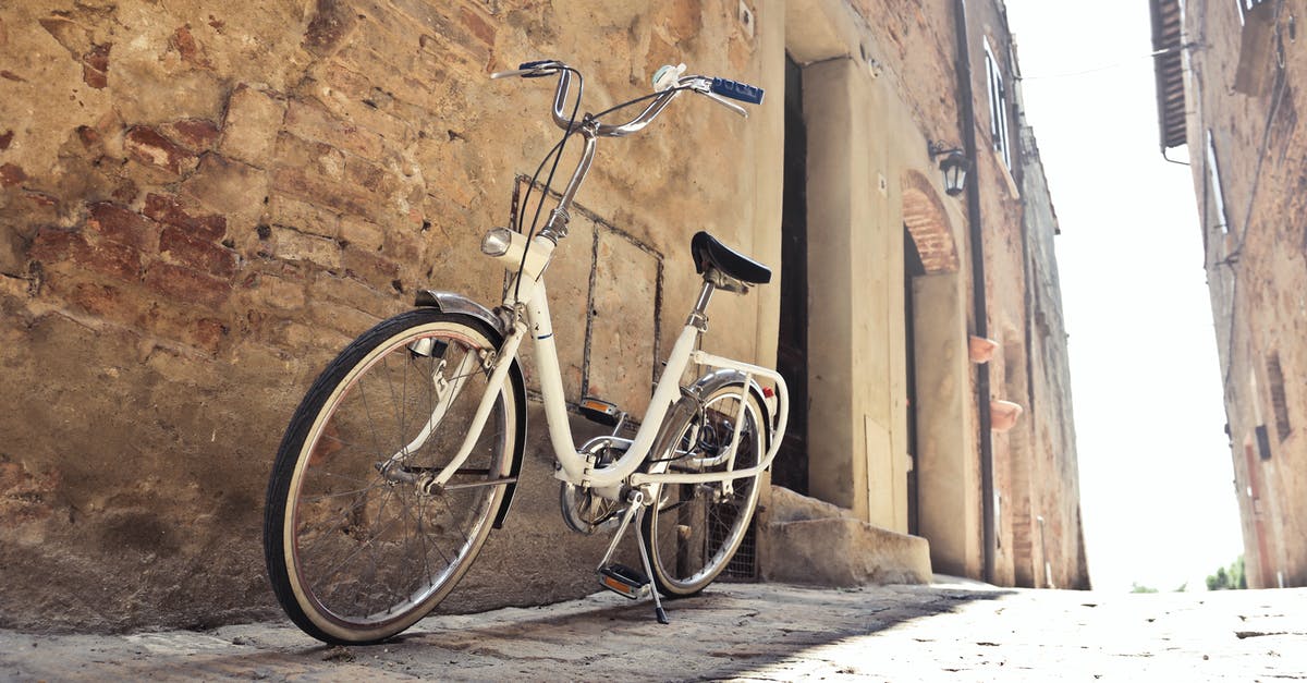 Bike transport from Haridwar to Bangalore - Bicycle parked on narrow street against old building with shabby walls in town