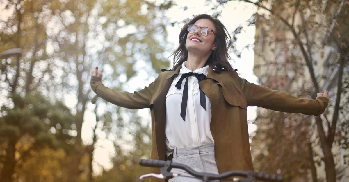 Biking from Whitehorse to Vancouver [closed] - Content woman in retro clothes on bicycle in street