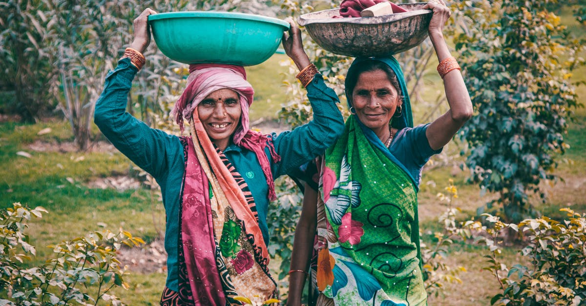 BIVS for Indian citizens applying outside of India - Two Women Wearing Traditional Dress Carrying Basins