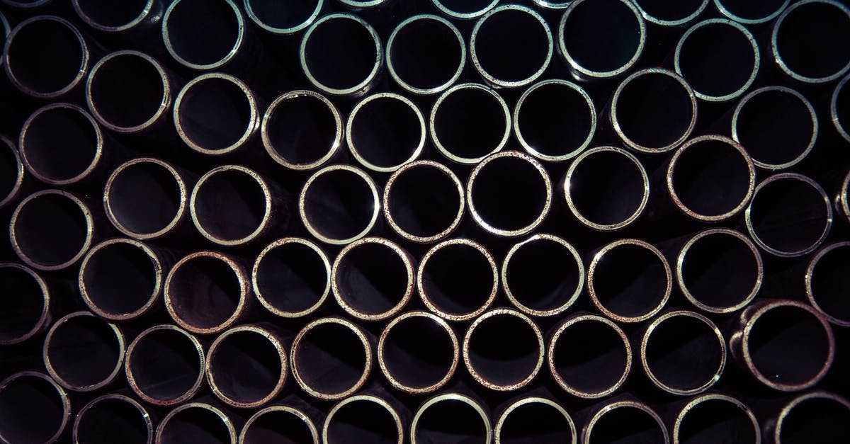 Black Labyrinth or Tube it in Waitomo? [closed] - Close Up Photo of Gray Metal Pipes