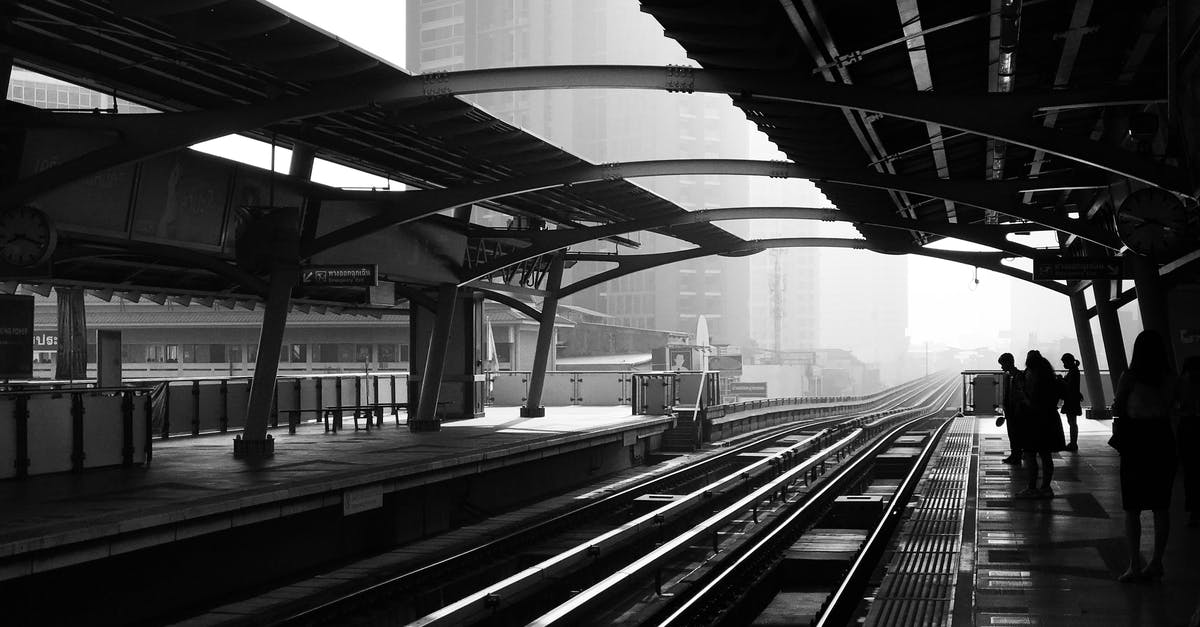 Board Chinese train at a different station (on-route) - Silhouettes of anonymous people standing on railway platform