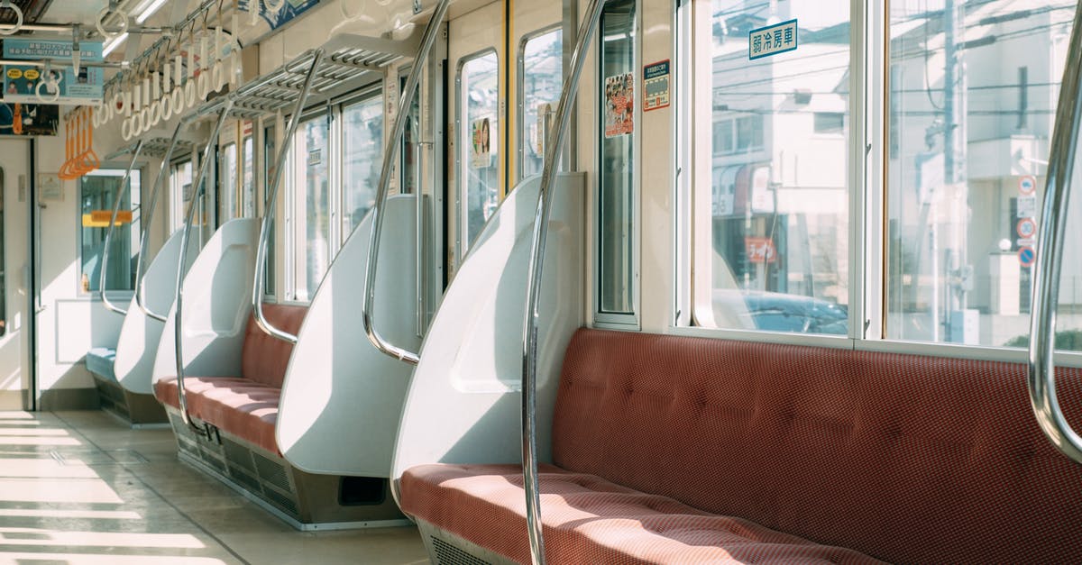 Board Chinese train at a different station (on-route) - Empty contemporary train in city on sunny day