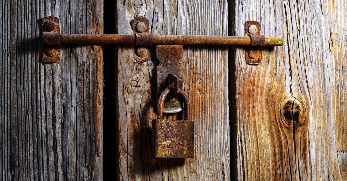 Boarding refusal at boarding gate - Brown Padlock on Wall