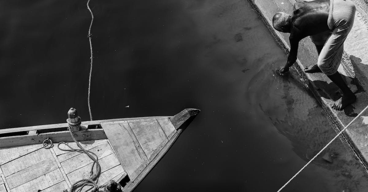 Boat tour on lake Titicaca? - Grayscale Photo of Man in Boat on Water
