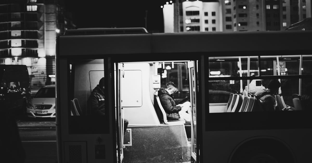 Bogotá–Medellín by bus - Grayscale Photo of Man in Black Jacket Sitting Inside Train