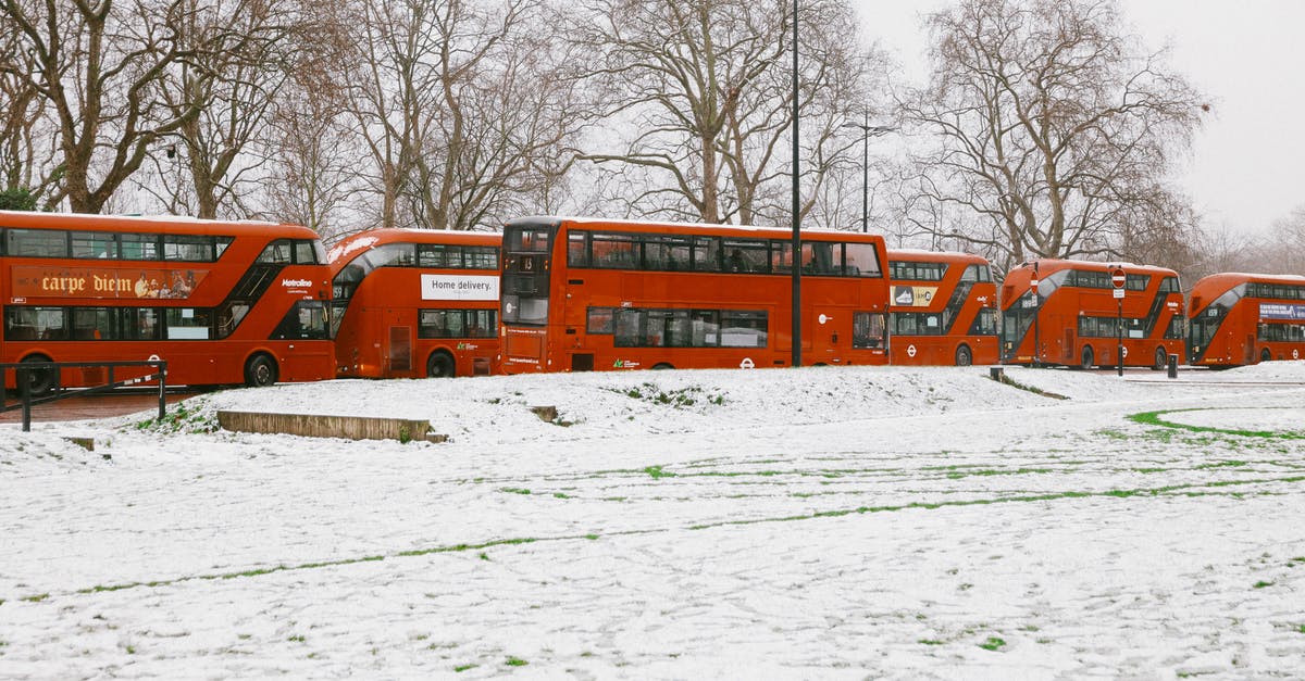 Bombay to San Francisco via Amsterdam and London [duplicate] - Red Double Decker Buses Near Snow-Covered Ground