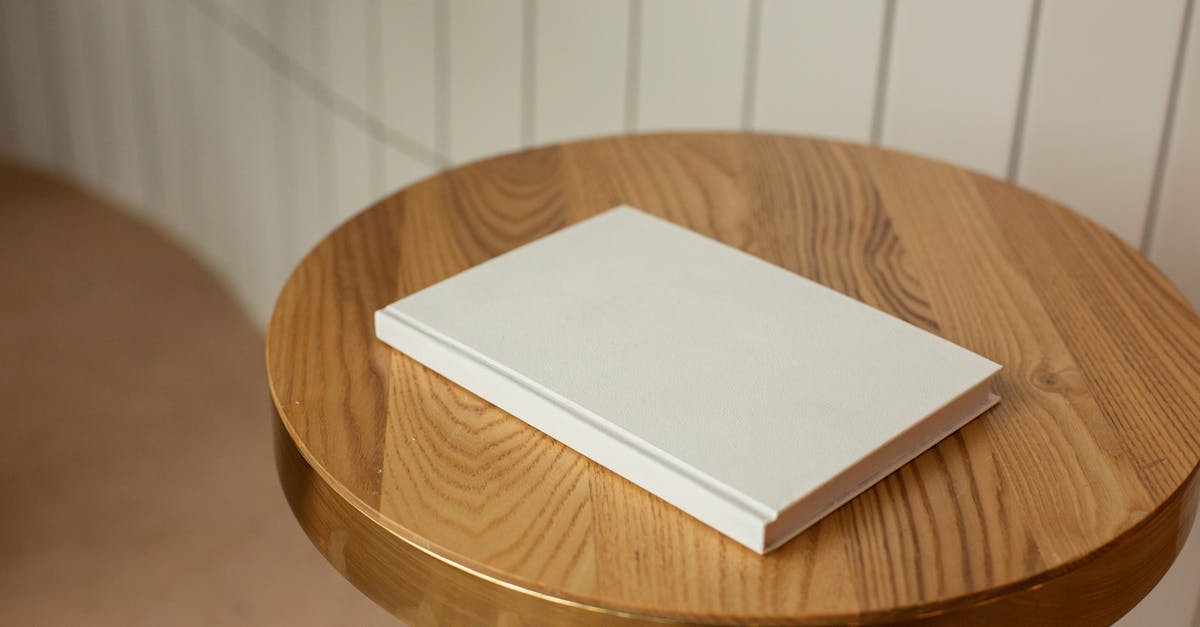 Book a JAL flight, marketed by AA: mileage earnings on Alaska? - From above of round shaped wooden table with blank white book on blurred background