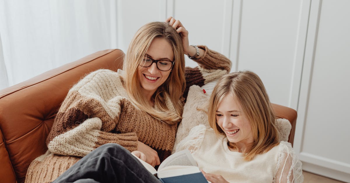 Book ahead in Bali? - Woman in White Sweater Sitting Beside Girl in White Sweater