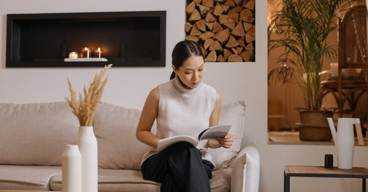 Booked/paid for room, not available upon arrival - Woman in White Tank Top Sitting on White Sofa Chair