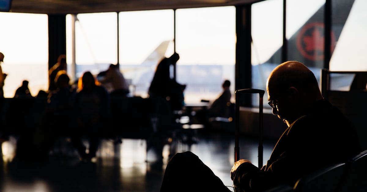 Booking a flight with a luggage limit via Adioso / Expedia - Silhouette of People Sitting Waiting to Board