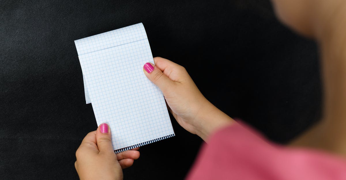 Booking guarantee with an empty debit card - Person Holding White Textile