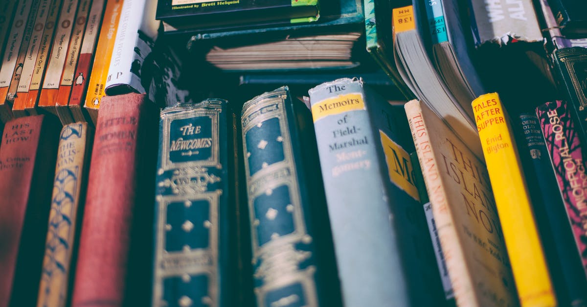 Booking Reference Number - Stack of Brown and Red Printed Hardbound Books