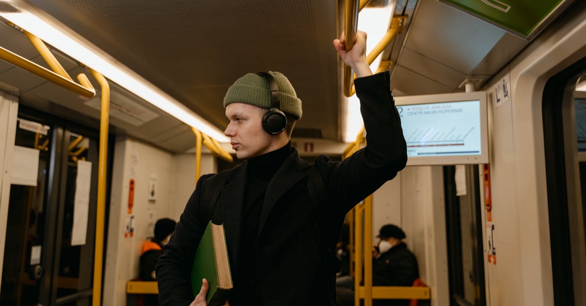 Booking train tickets on RENFE site - 
A Man Listening to Music while Riding a Train