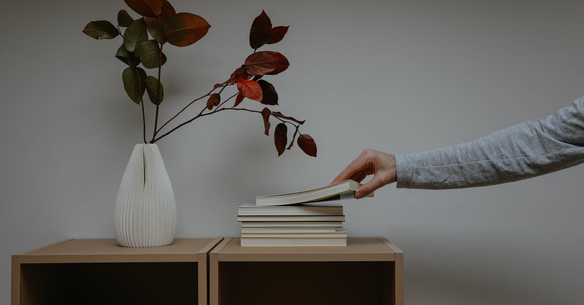 Booking with Czech Airlines but getting on SmartWings flight, any consequences? - Photo of a Person's Hand Getting a Book Beside a Vase