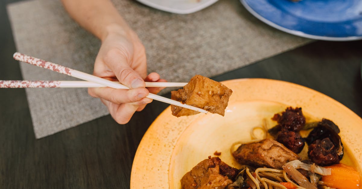 Booking with Czech Airlines but getting on SmartWings flight, any consequences? - Person Holding Chopsticks and Pasta on Plate