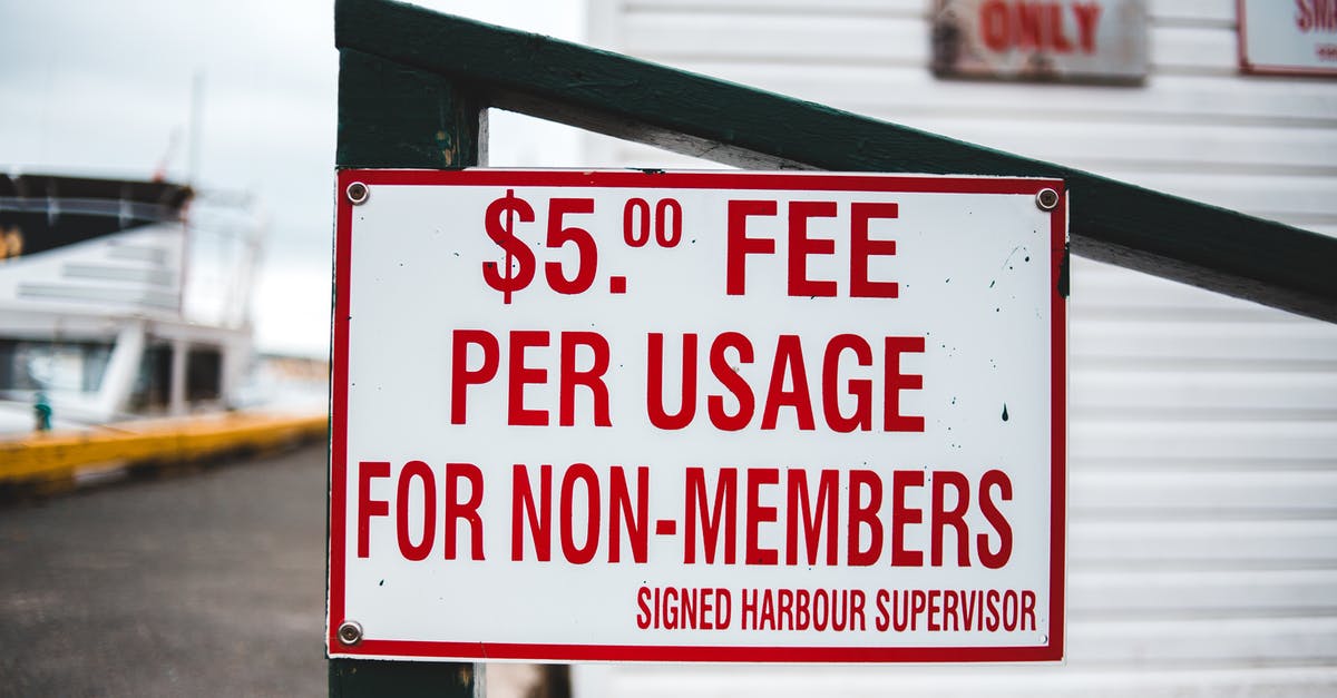 Booking.com cancelation fee - Signboard with entrance price information outside harbor cottage