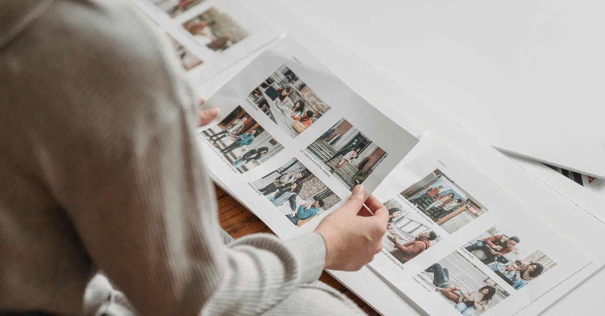 booking.com: do I need to show printed confirmations? - Crop unrecognizable woman looking through printed photos in album