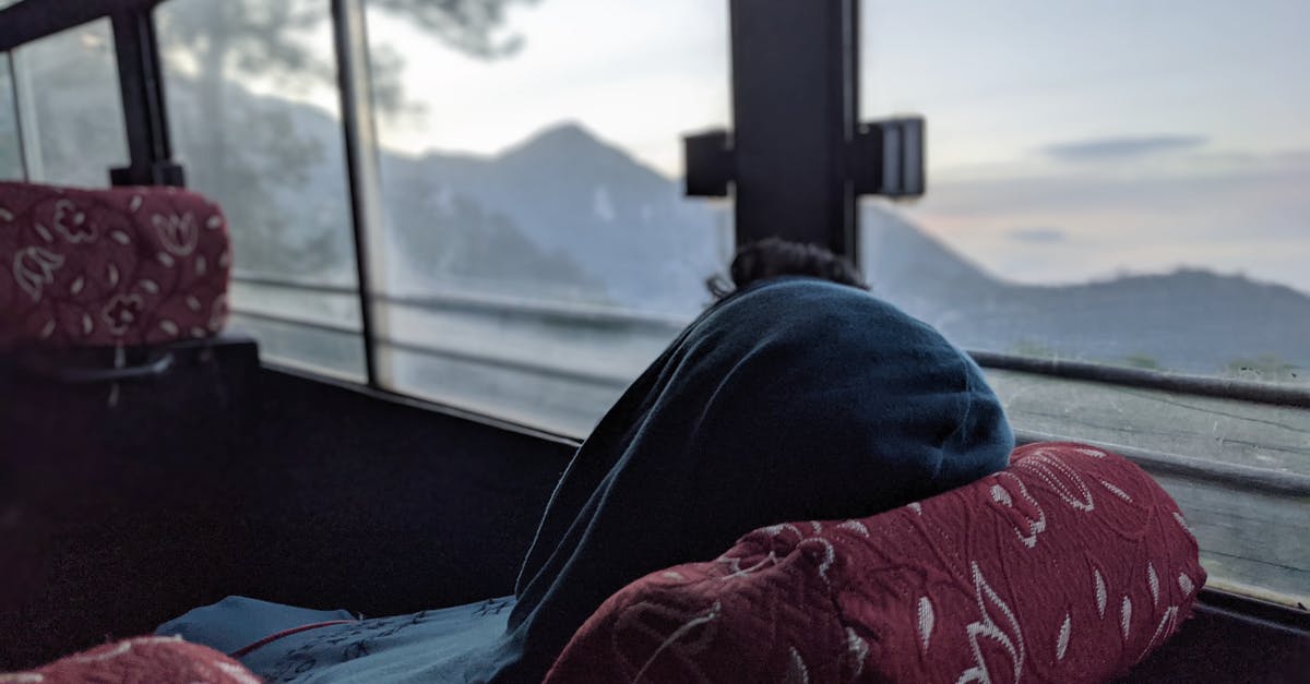 Boquete to Panamá by bus on 3rd March - A Person in Blue Hoodie Relaxing Inside a Transport Vehicle