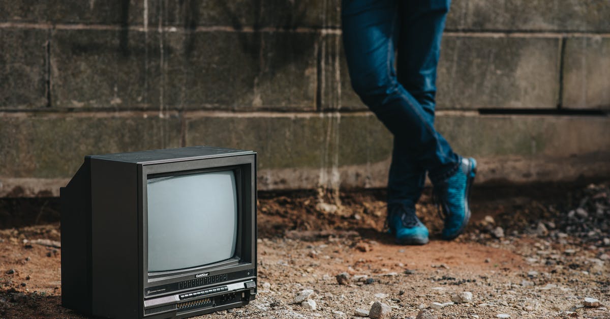 Border crossing on Curonian Spit - Crop person standing near fence and old TV