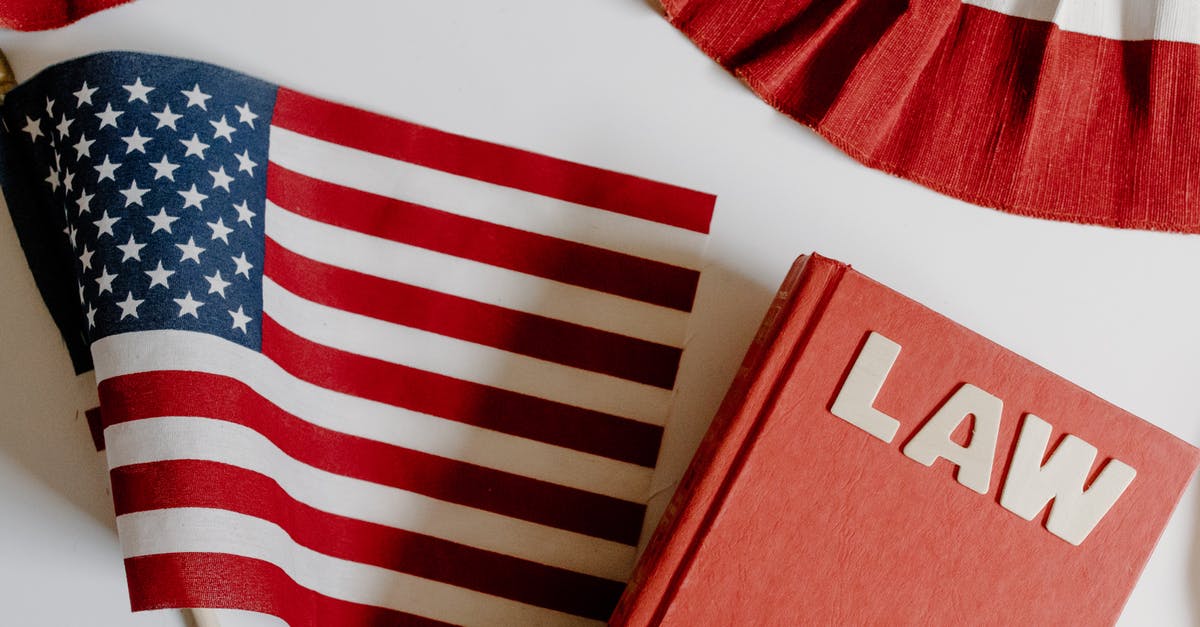 Border patrol questions USA to Canada [closed] - American Flag Beside a Law Book on White Background