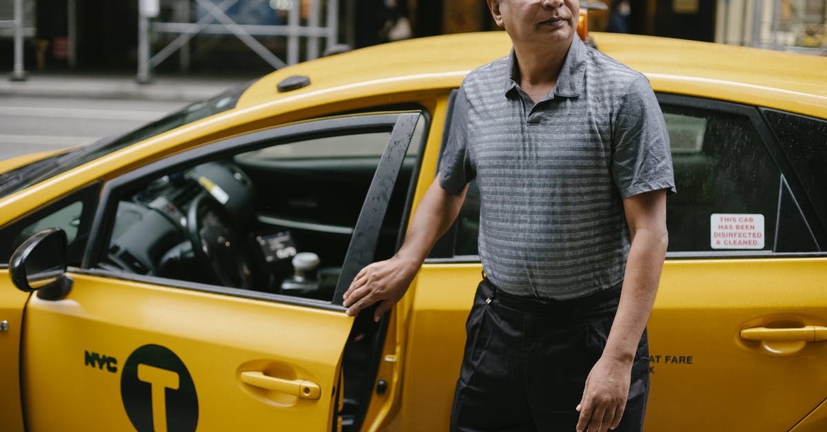 Boro cab service in New York City - Focused taxi driver at cab on street