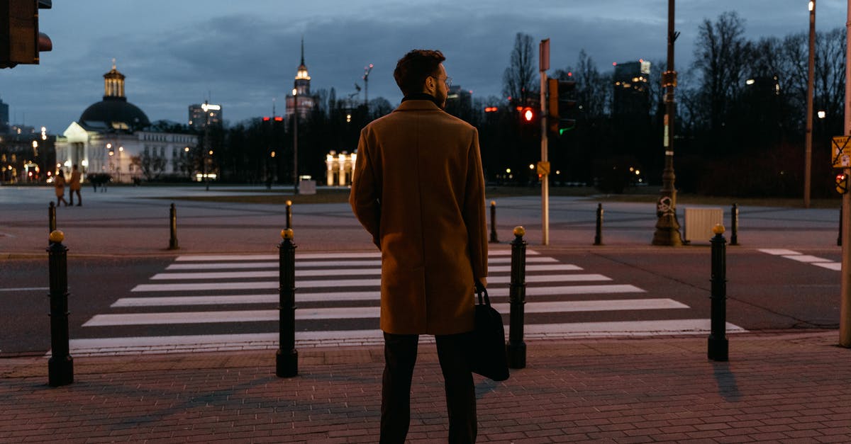 Boston to Europe and back, mixed fare? - Man Wearing Brown Coat Standing on the Street