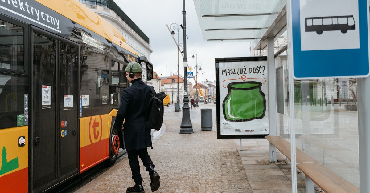 Boston to Europe and back, mixed fare? - Man in Black Balzer Walking Towards the Bus