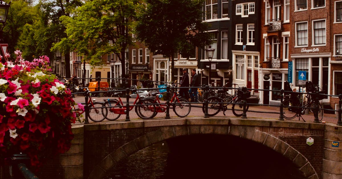 Boxed bike on trains in Amsterdam & Brussels - Photo of Bicycles Near Bridge at Daytime