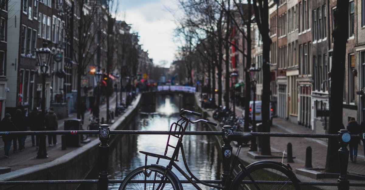 Boxed bike on trains in Amsterdam & Brussels - Bicycle Parked on a Bridge