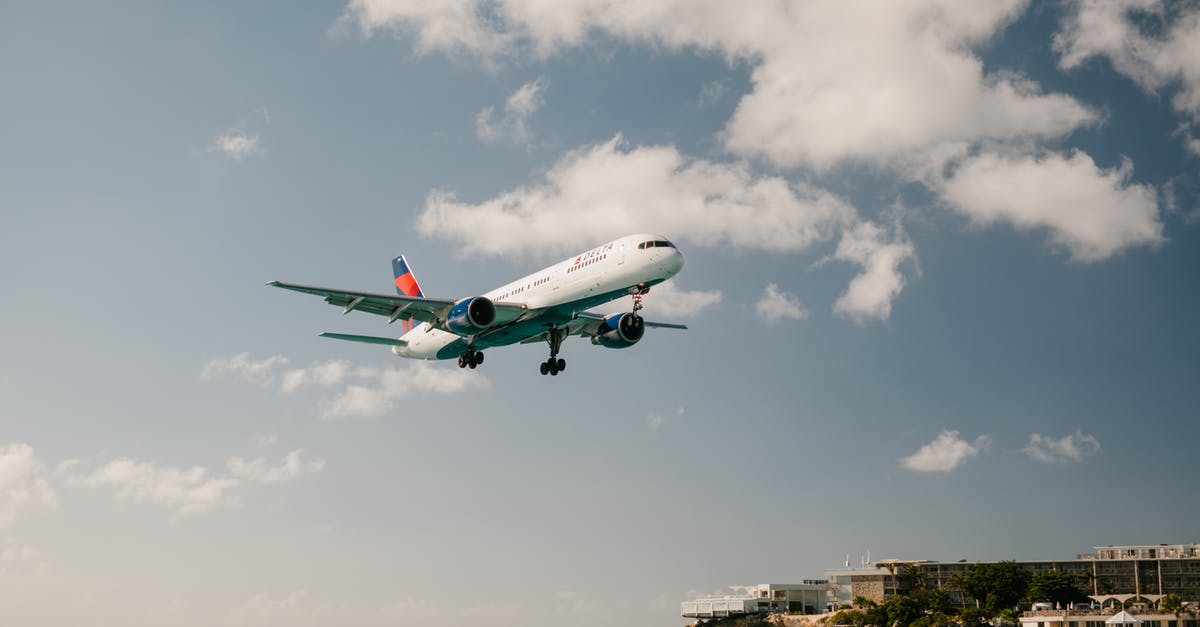 Breaking the connecting flight - White and Blue Airplane Flying over the Sea