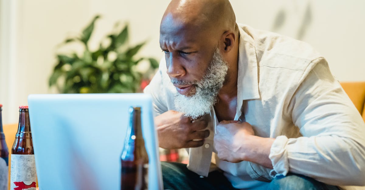 Bringing Beer into the Philipines - Man in White Dress Shirt Sitting in Front of White Laptop