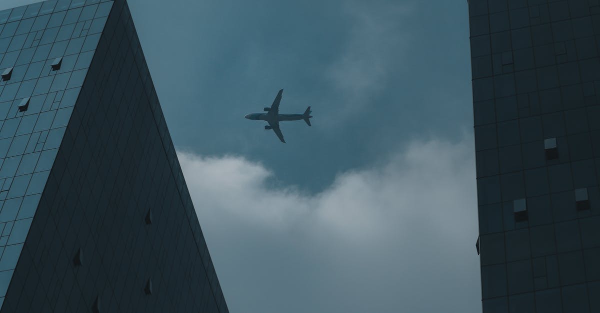 Bringing carseat on flight - Airplane Flying above Buildings