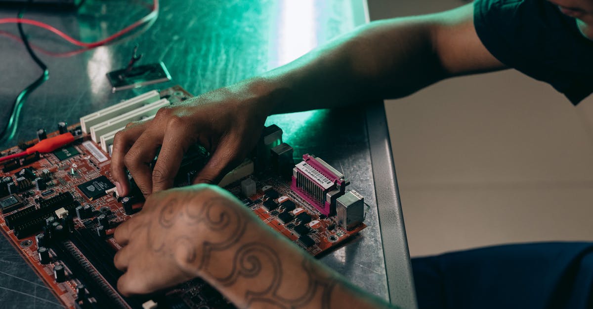 Bringing computer hardware to Albania crossing several Balkan countries - A Man Assembling a Computer Part