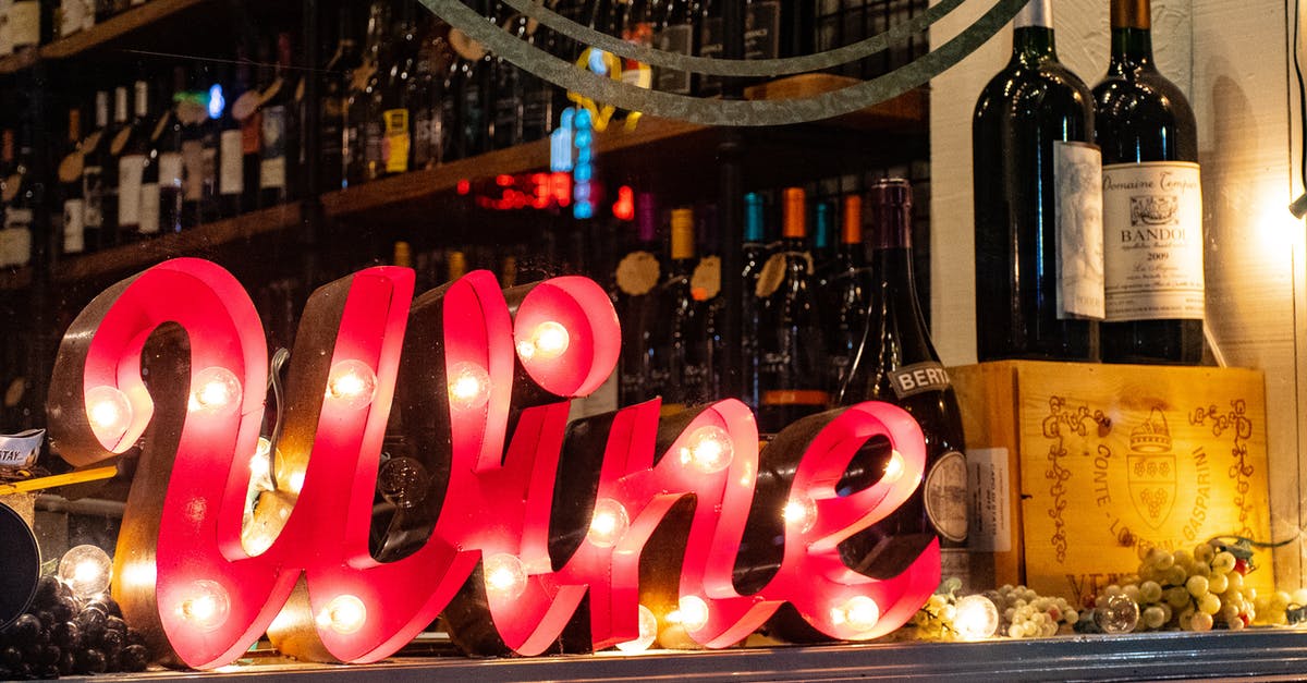 Bringing coumarin-containing liquor into the USA - Red Wine Marquee Signage on Table