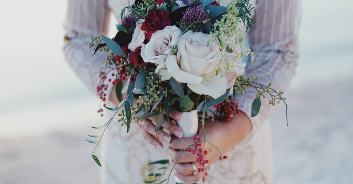 Bringing engagement ring to singapore which was bought in germany - Woman Holding Red and White Rose Bouquet