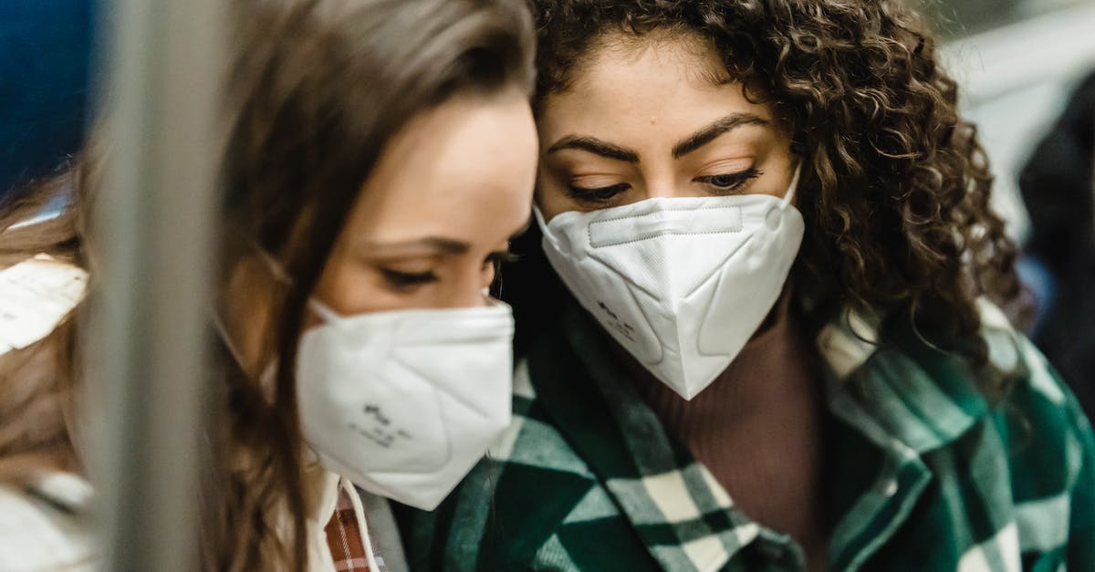 Bringing HIV Medications from Pakistan to Kyrgyzstan for a friend - Young women in medical masks riding in subway