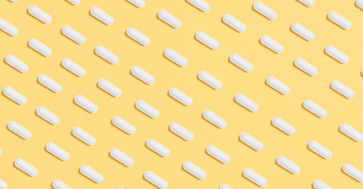 Bringing prescription drugs into Bangkok - White Capsules on Yellow Background
