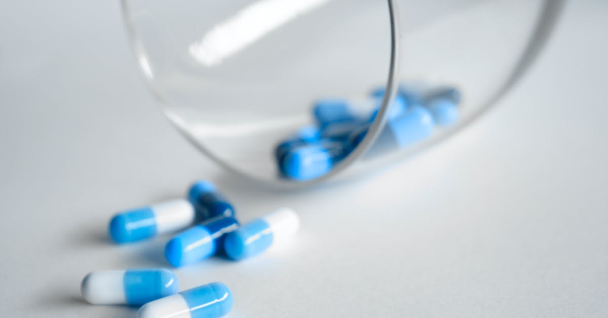 Bringing prescription drugs into Bangkok - Depth Photography of Blue and White Medication Pill