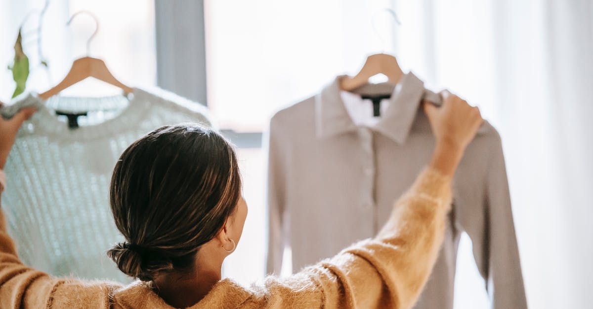 Bringing work goods across border - Anonymous woman choosing clothes in store