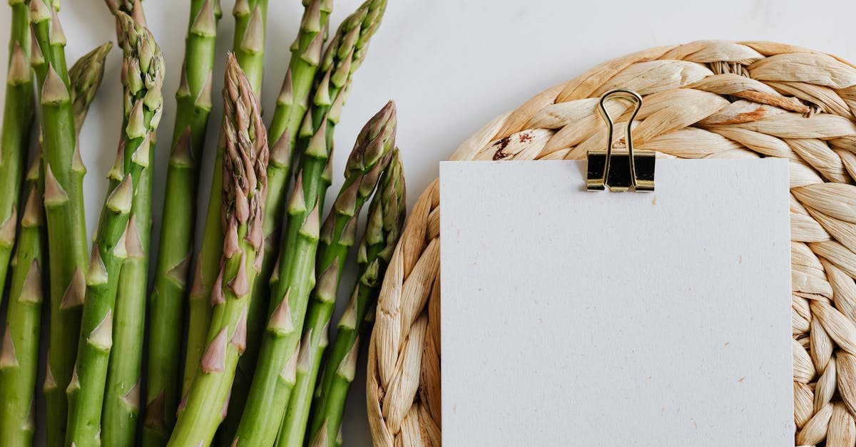 Bucket list - Trans Australian railway - food and stopover issues - Top view of asparagus pods with sheets of paper fastened by paper clip on white desktop