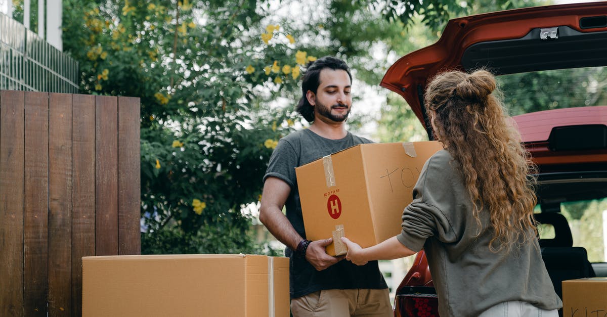 Busch Gardens Williamsburg VA without a car - Boyfriend and girlfriend in casual wear helping each other with unpacking car while moving in together on sunny summer day