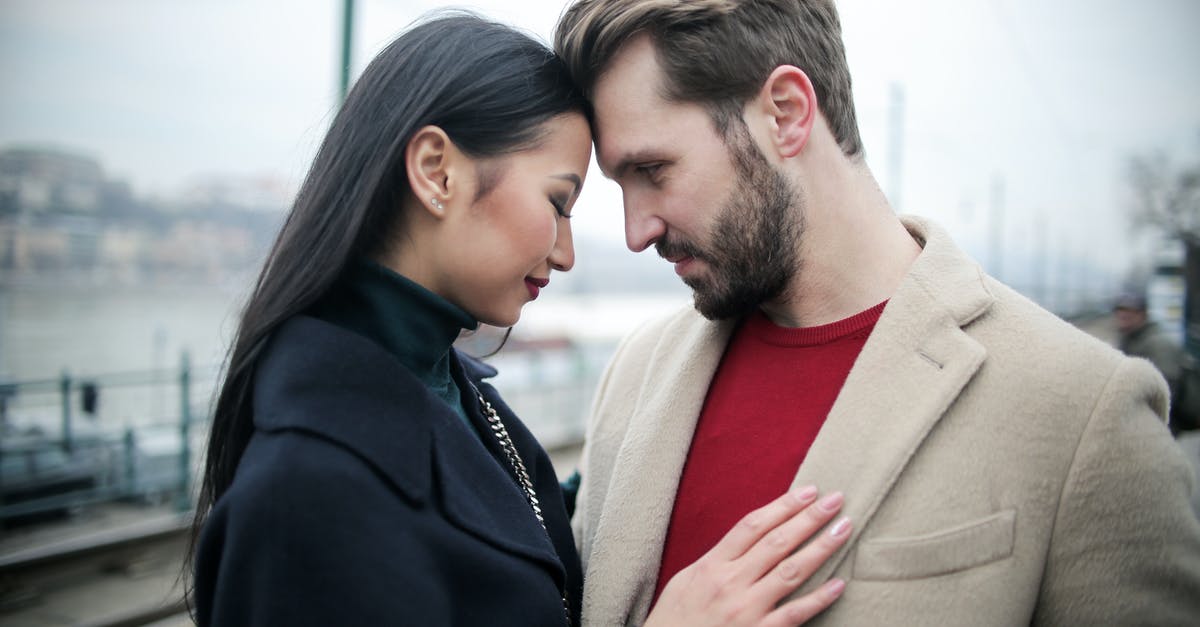 Business Invitation Date only 8 days before Visa Submission - Happy multiracial couple hugging on waterfront while having romantic date in city