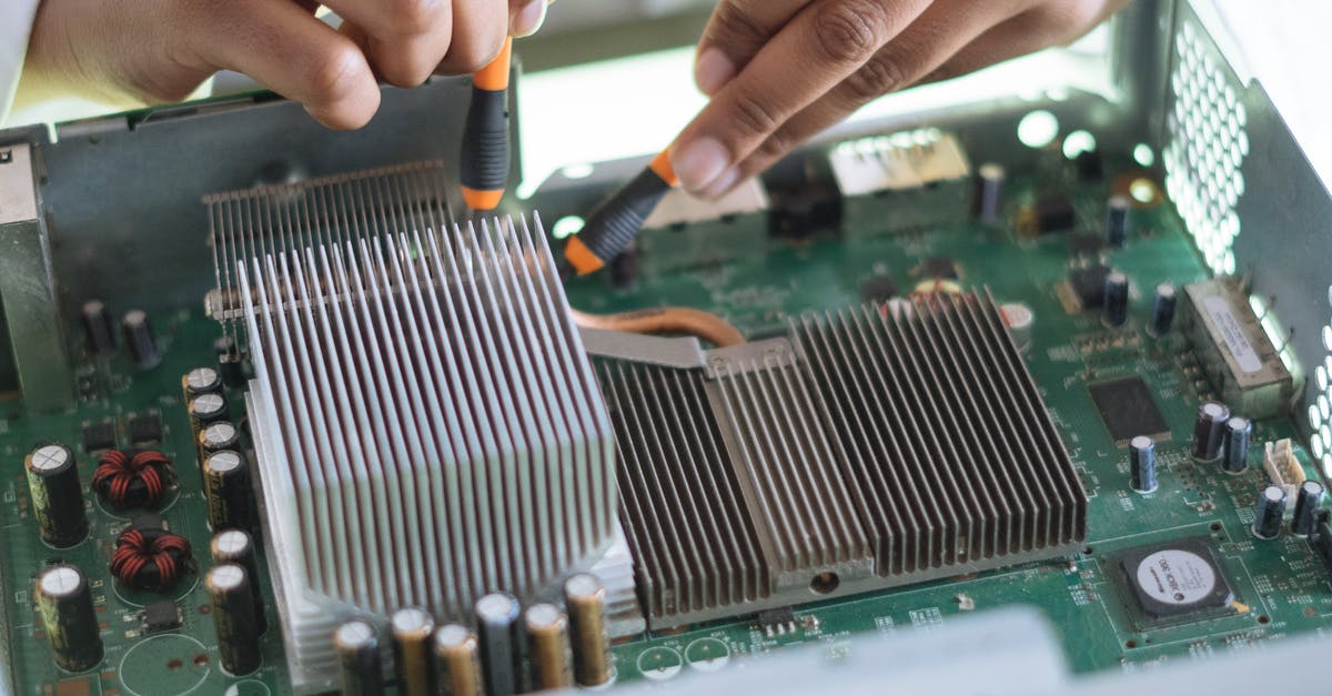 Business visit to EU for equipment installation - Crop technician checking contacts on motherboard in workshop