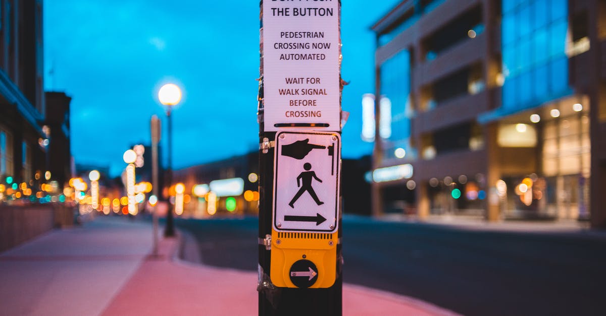 Button for pedestrian traffic lights in Germany - Pedestrian call button on crosswalk in contemporary city in evening