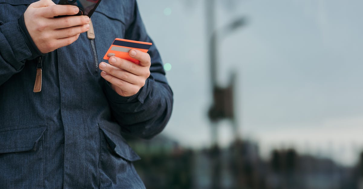 Buy mobile data in Morocco with Inwi SIM card - Male taking photo of credit card on smartphone on street in daytime