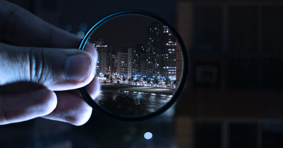 Buying a second hand Fujinon lens in Osaka - Person Holding Magnifying Glass