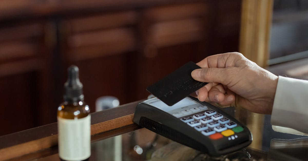 Buying a sim card in Italy - Person Holding a Black Card 