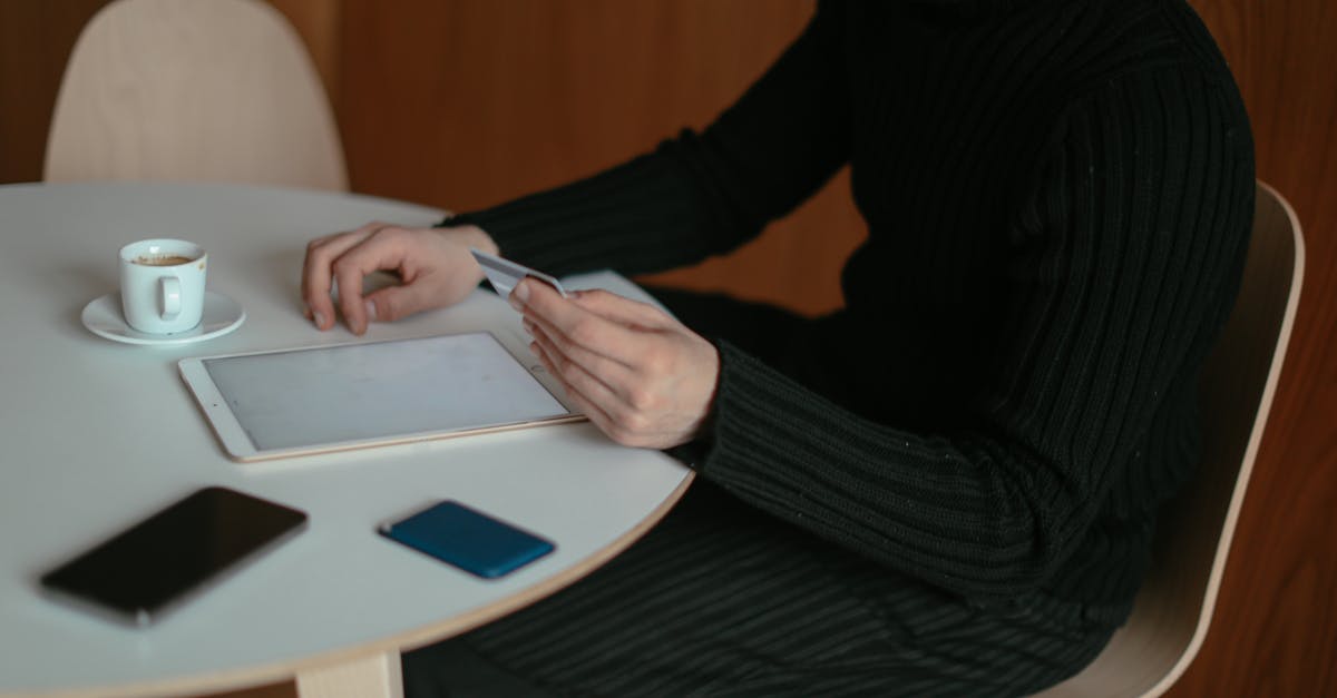 Buying airfare that permits a 'Free Stopover' - Man Shopping Online at Home Using his Tablet and Credit Card 