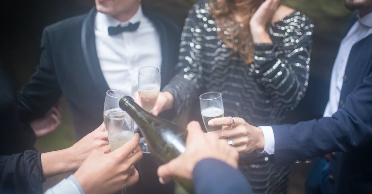 Buying alcohol in Prague - Man in Black Suit Jacket Holding Clear Glass Bottle