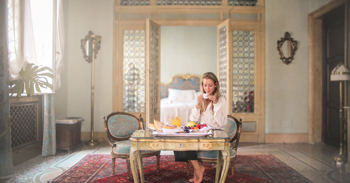 Buying hotel breakfast without having a room? - Woman enjoying breakfast in luxury hotel room